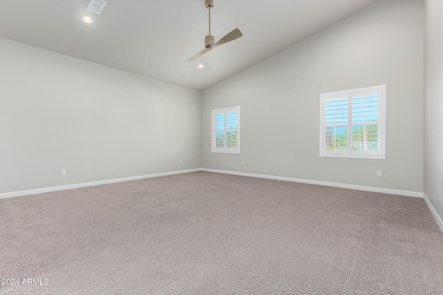 empty room featuring carpet floors, high vaulted ceiling, plenty of natural light, and ceiling fan