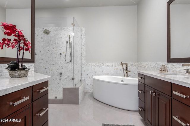 bathroom featuring tile walls, vanity, and shower with separate bathtub