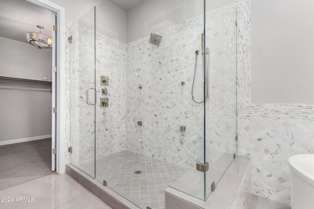 bathroom with tile walls, tile patterned flooring, and an enclosed shower