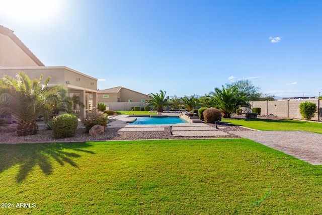 view of pool with a yard and a patio area