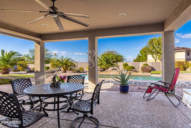 view of patio with ceiling fan and a fenced in pool