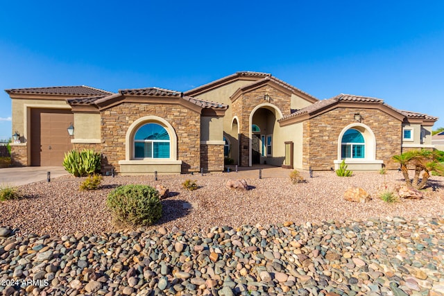 mediterranean / spanish-style home featuring a garage