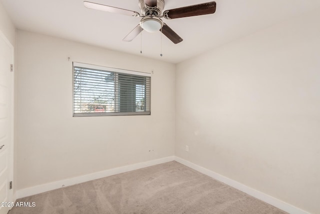 empty room with light colored carpet and ceiling fan