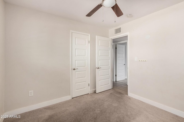 unfurnished bedroom with ceiling fan and carpet