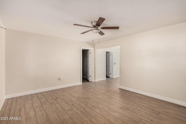 empty room featuring ceiling fan and light hardwood / wood-style floors