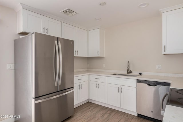 kitchen with white cabinetry, appliances with stainless steel finishes, and sink