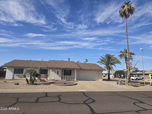 ranch-style home with a garage and concrete driveway