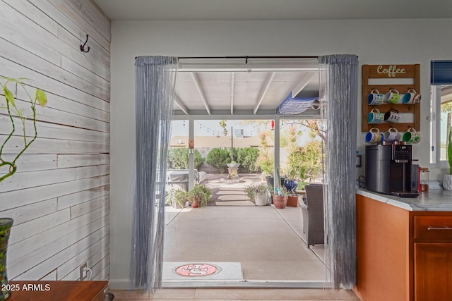 entryway with wood walls