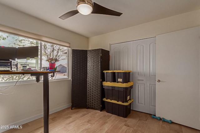 bedroom with ceiling fan, wood finished floors, and baseboards