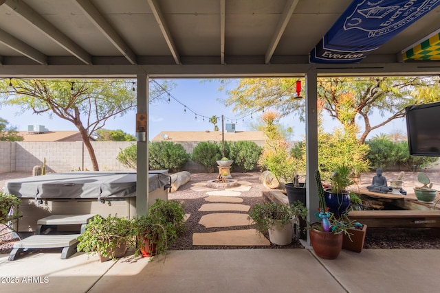 view of patio / terrace featuring a fenced backyard and a hot tub