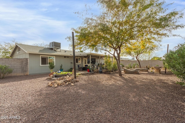 back of house featuring fence, central AC unit, and a patio