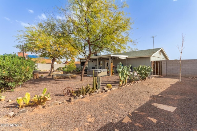 rear view of property with fence and a patio