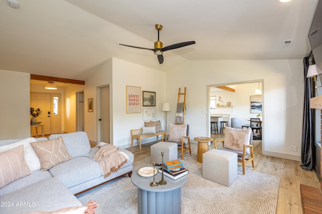 living room with lofted ceiling, light hardwood / wood-style flooring, and ceiling fan