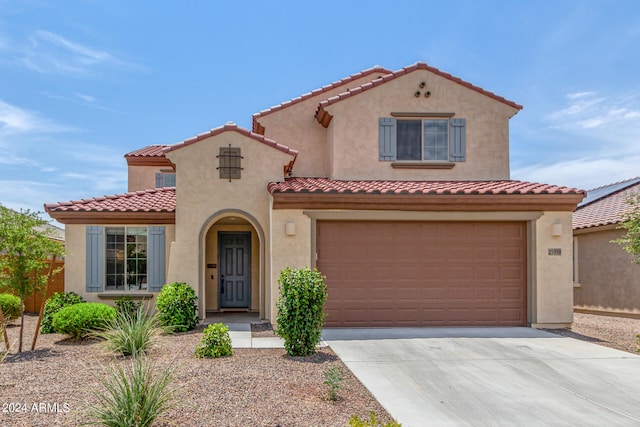 mediterranean / spanish-style house with a garage