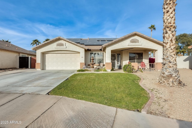 view of front of home with a garage, a front lawn, and solar panels