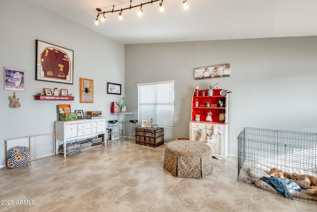 living area with vaulted ceiling and light tile patterned floors