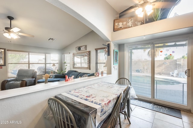 tiled dining room featuring lofted ceiling and ceiling fan