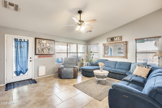 living room featuring lofted ceiling, ceiling fan, and light tile patterned flooring