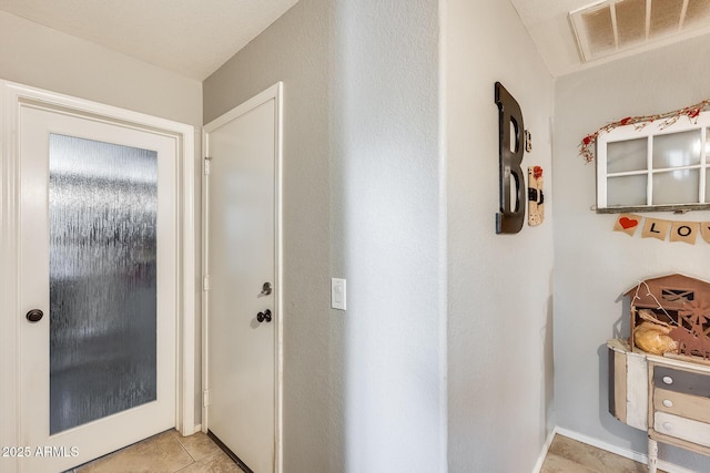 hall featuring light tile patterned flooring