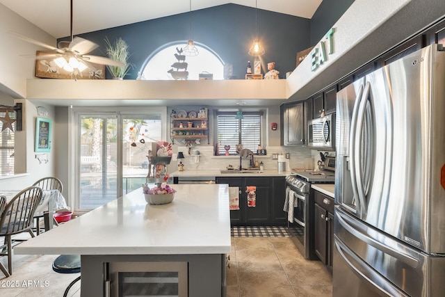 kitchen featuring sink, stainless steel appliances, a center island, wine cooler, and decorative light fixtures