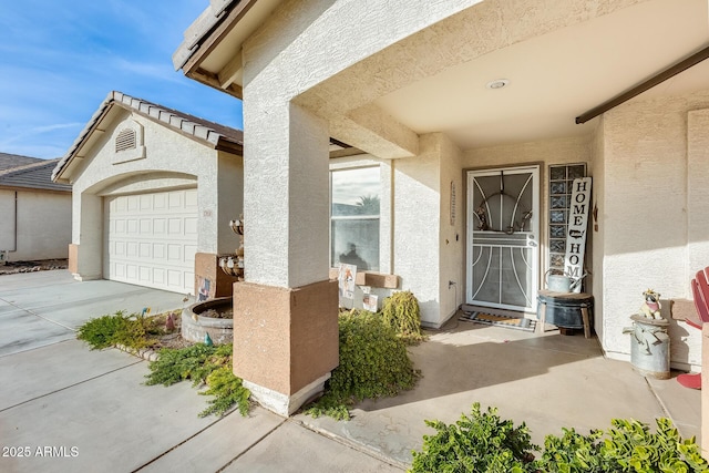 view of exterior entry featuring a garage