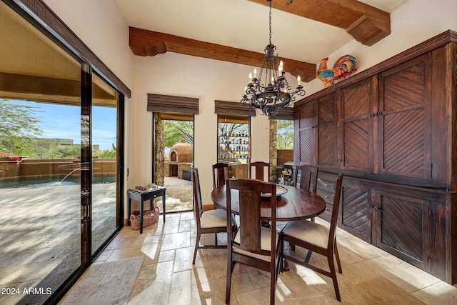 dining area featuring beamed ceiling and a chandelier