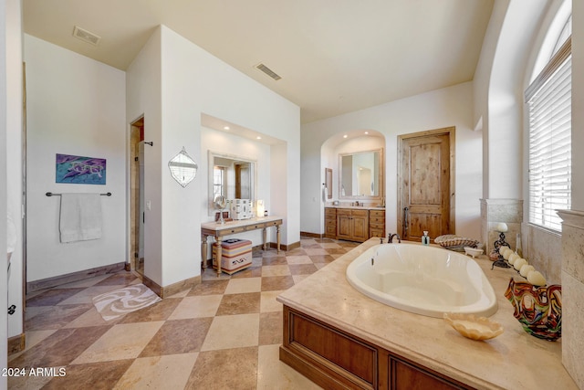 bathroom featuring vanity and plus walk in shower