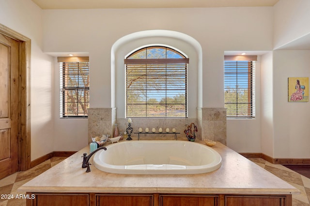 bathroom with a washtub and plenty of natural light