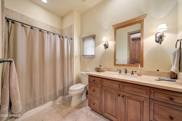 bathroom with tile patterned flooring, vanity, and toilet