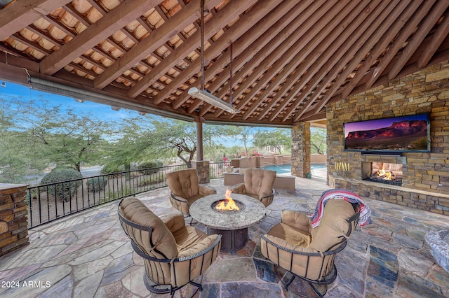 view of patio / terrace with an outdoor living space with a fireplace