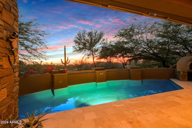 view of pool at dusk