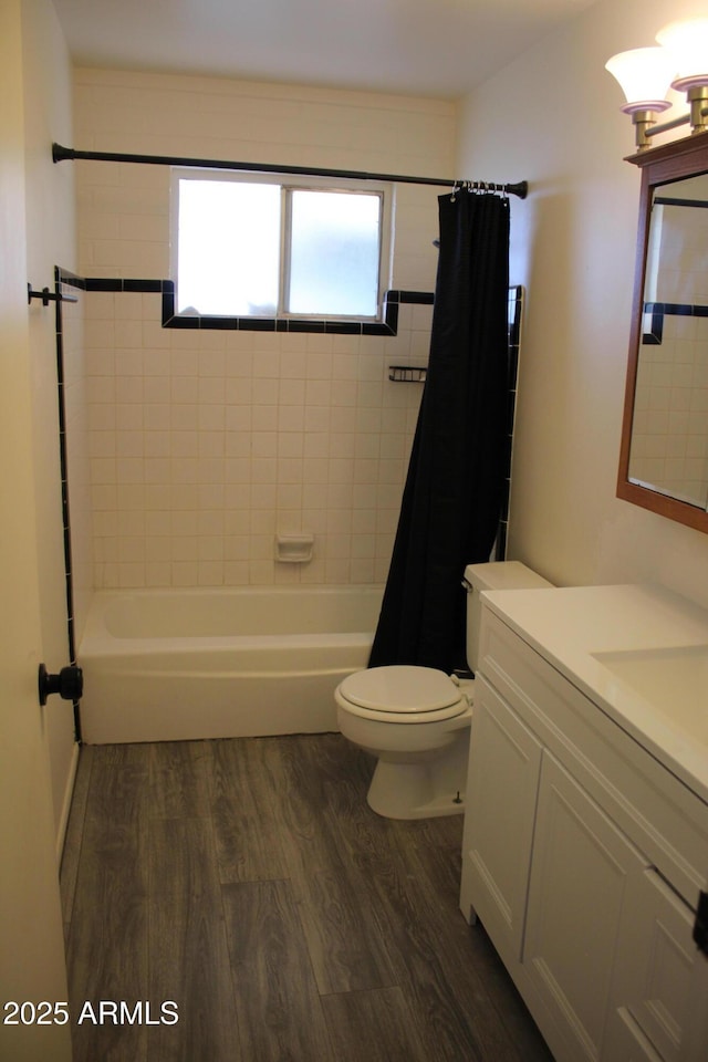 full bathroom featuring shower / tub combo with curtain, vanity, toilet, and wood finished floors