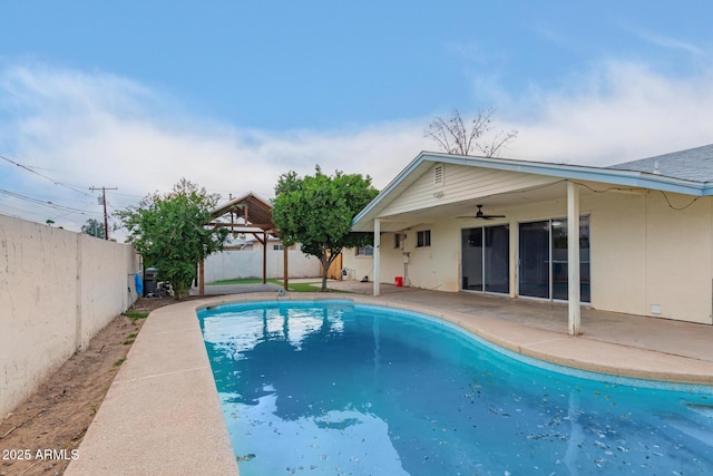 view of pool with a gazebo, a ceiling fan, a fenced backyard, and a patio area