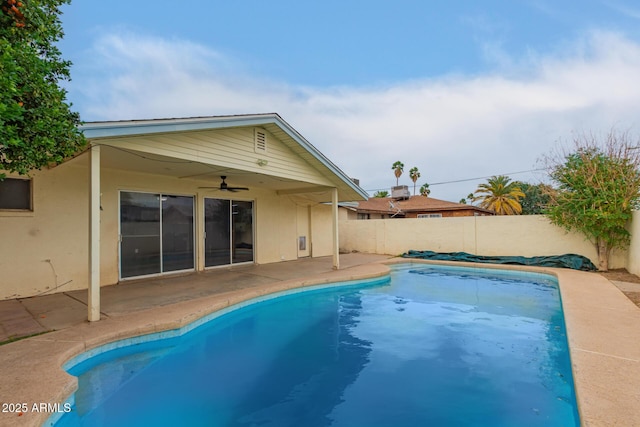view of pool with ceiling fan, a fenced backyard, and a patio