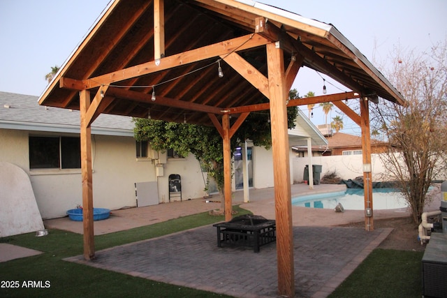 view of patio / terrace featuring a fenced backyard, a fenced in pool, and a gazebo