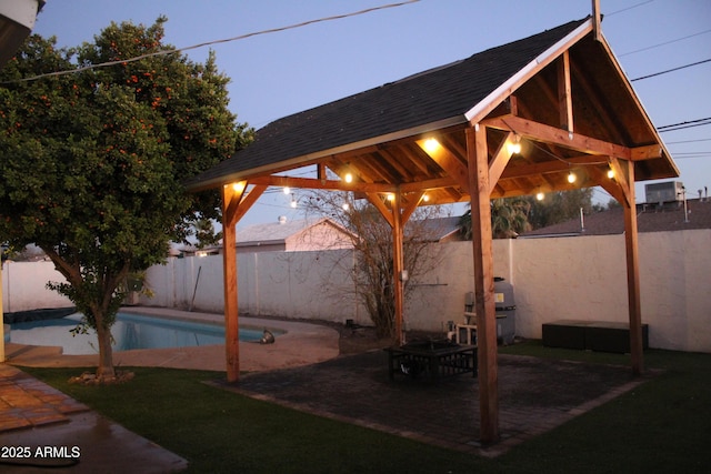 view of patio / terrace with a fenced backyard, a grill, a fenced in pool, and a gazebo