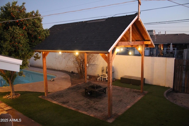 view of patio / terrace with a gazebo, a fenced backyard, and a fenced in pool