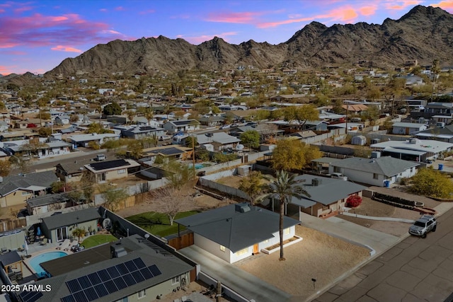 aerial view at dusk featuring a mountain view