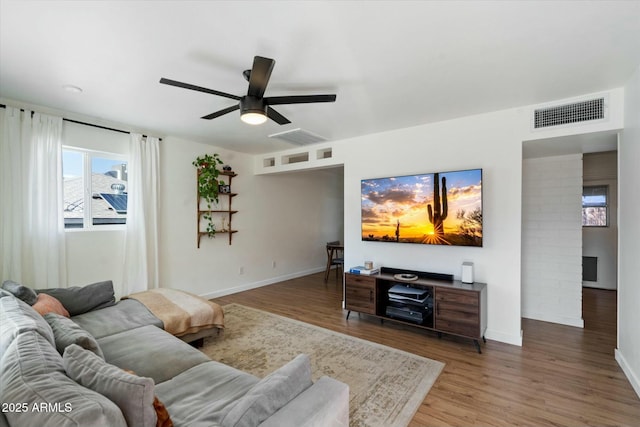 living room with hardwood / wood-style floors and ceiling fan