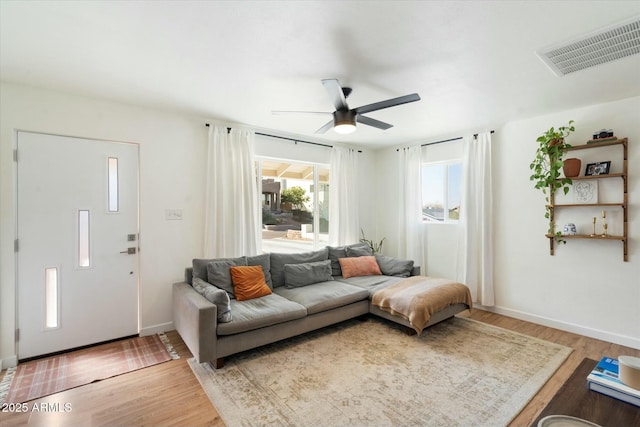 living room featuring ceiling fan and wood-type flooring