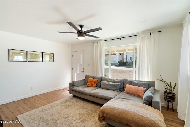 living room with hardwood / wood-style floors and ceiling fan