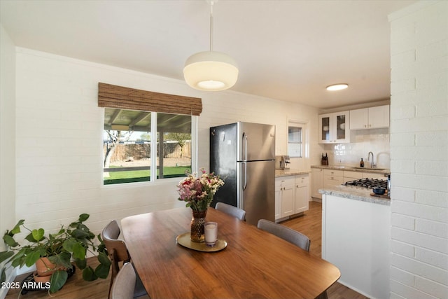 dining space featuring sink and wood-type flooring