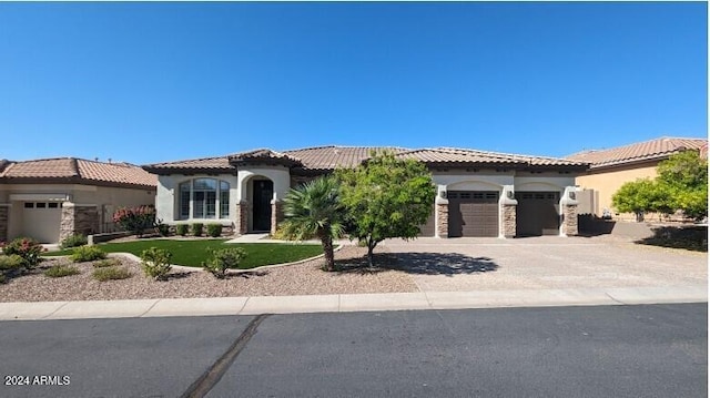 mediterranean / spanish-style home featuring a garage