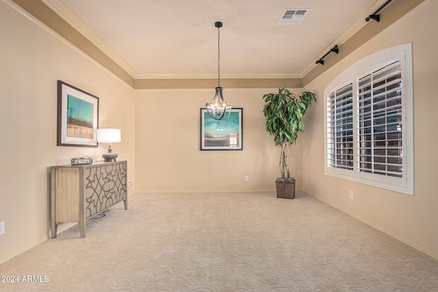 empty room with carpet, a chandelier, and ornamental molding