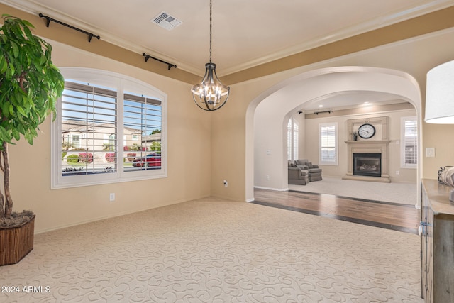 living room with light hardwood / wood-style flooring, a chandelier, and ornamental molding