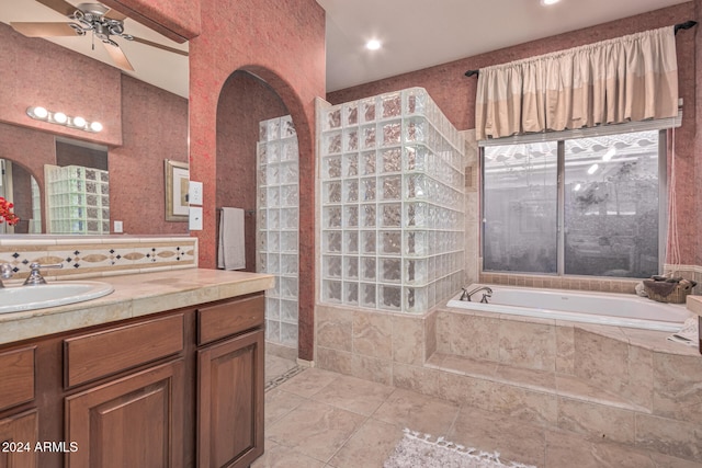 bathroom with ceiling fan, vanity, lofted ceiling, and shower with separate bathtub