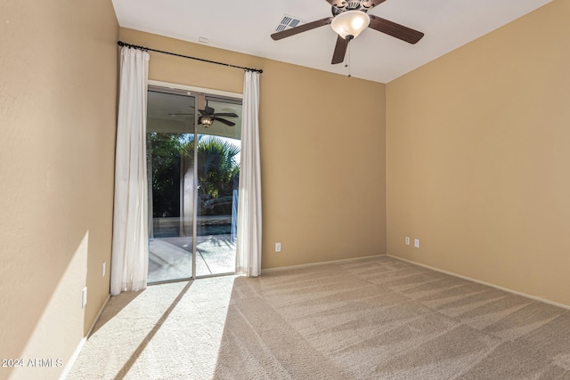 carpeted spare room featuring ceiling fan