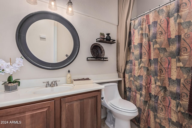 bathroom featuring vanity, toilet, and walk in shower