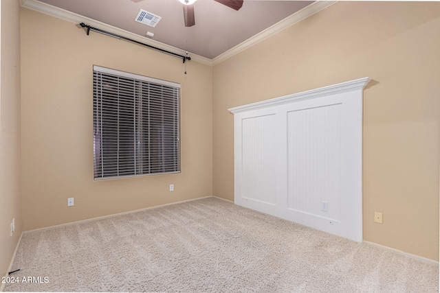 unfurnished bedroom with carpet, ceiling fan, and crown molding