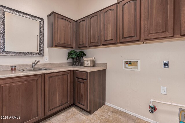 clothes washing area with electric dryer hookup, light tile patterned floors, sink, and hookup for a washing machine